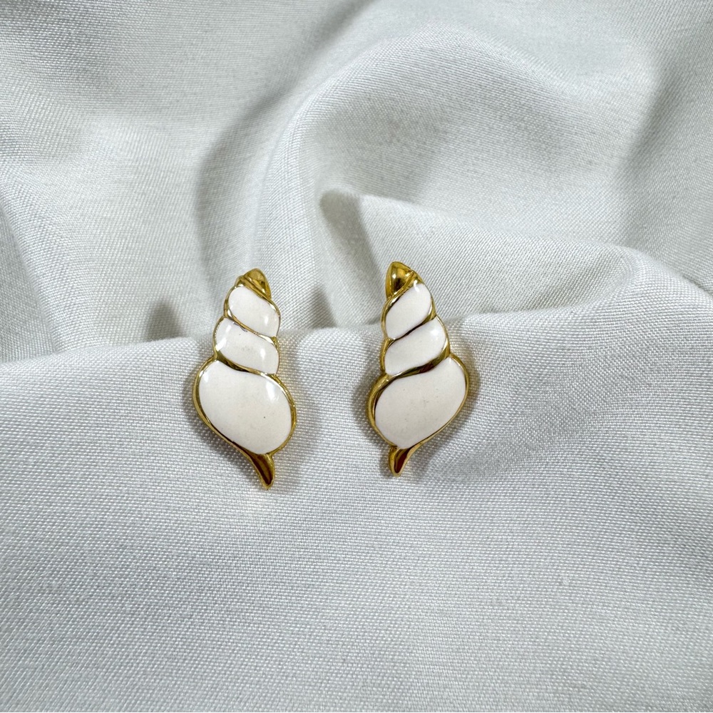 Vintage shell design post earrings in gold tone and off white enamel.